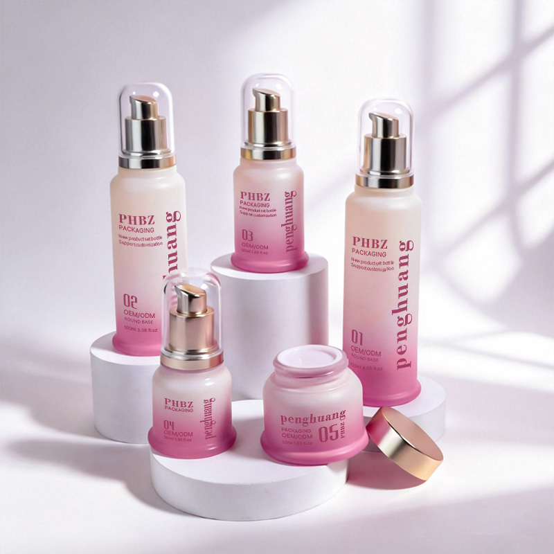 Custom printed gradient glass skincare bottle set with gold pump cap